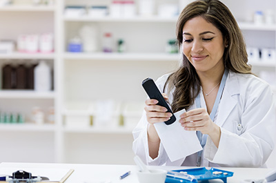 female pharmacist stapling papers