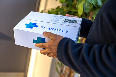 man holding pharmacy delivery box