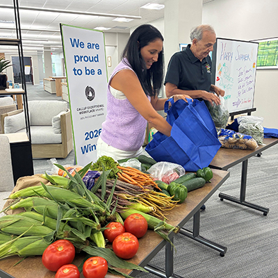 Woman and man putting produce into bags