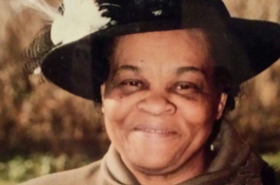 A photograph of Sherry’s mother Daisy smiling and wearing a large hat.