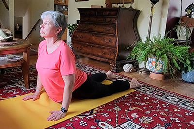 women stretching her back on an exercise mat